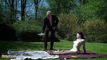 Play A brunette carded by an old man on the green grass